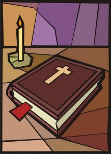 Bible with candle