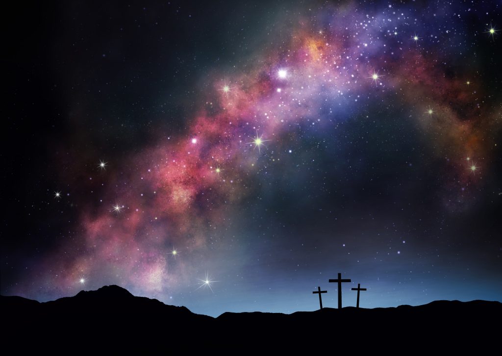 Three crosses on a hillside under the Milky Way